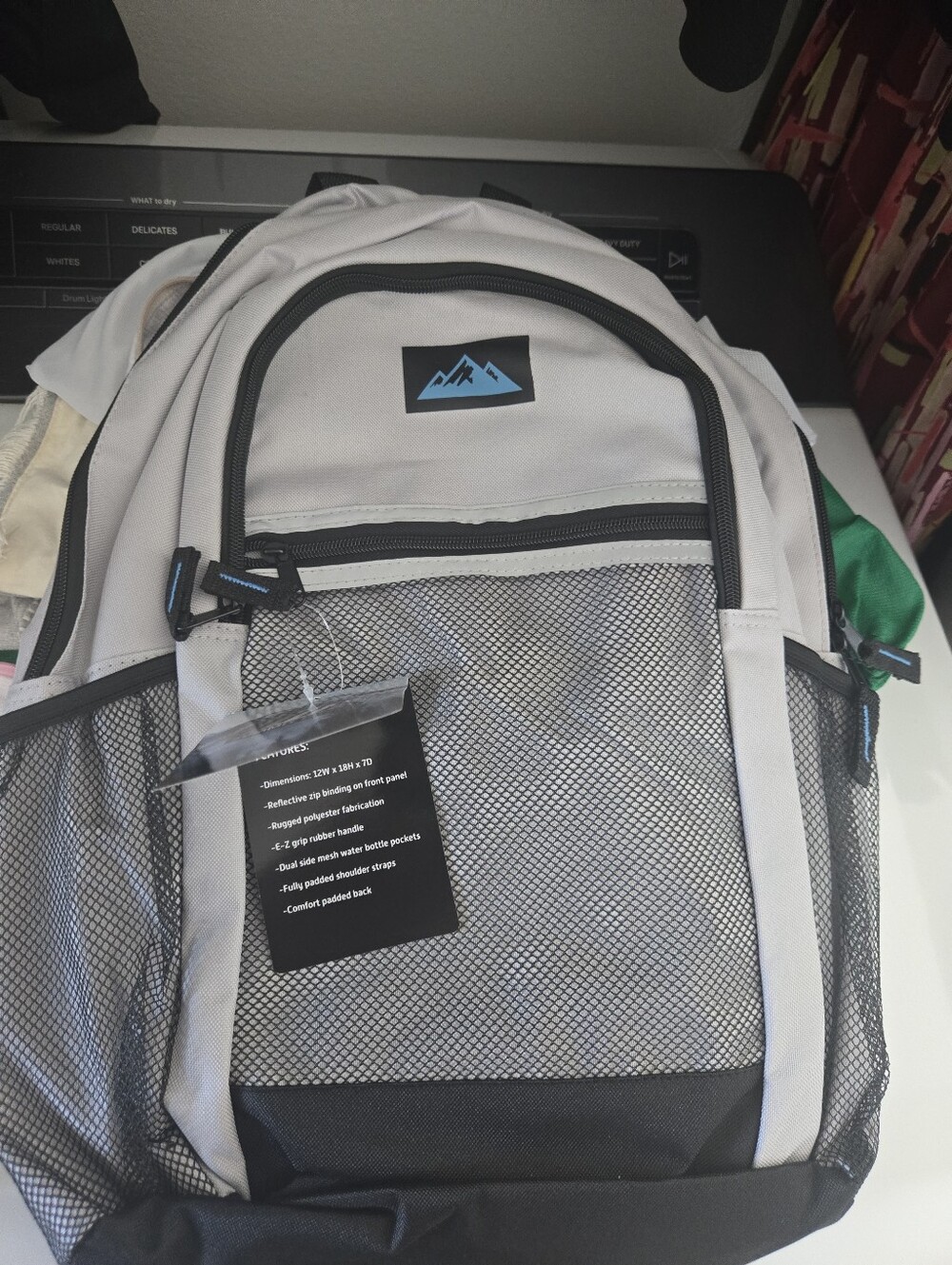 Summit Ridge Gray backpack with reflective zip binding, rugged polyester fabric